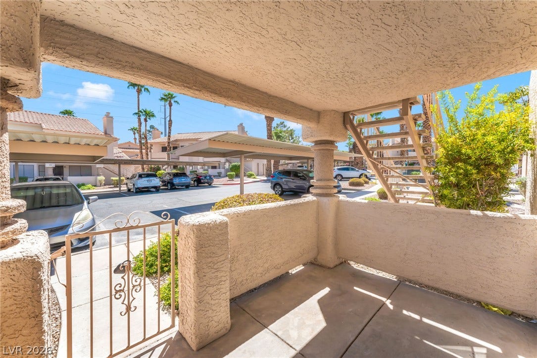 1017 Falconhead Lane, #102, Las Vegas, NV 89128 A private gated patio provides a shaded outdoor space directly off the entrance.
