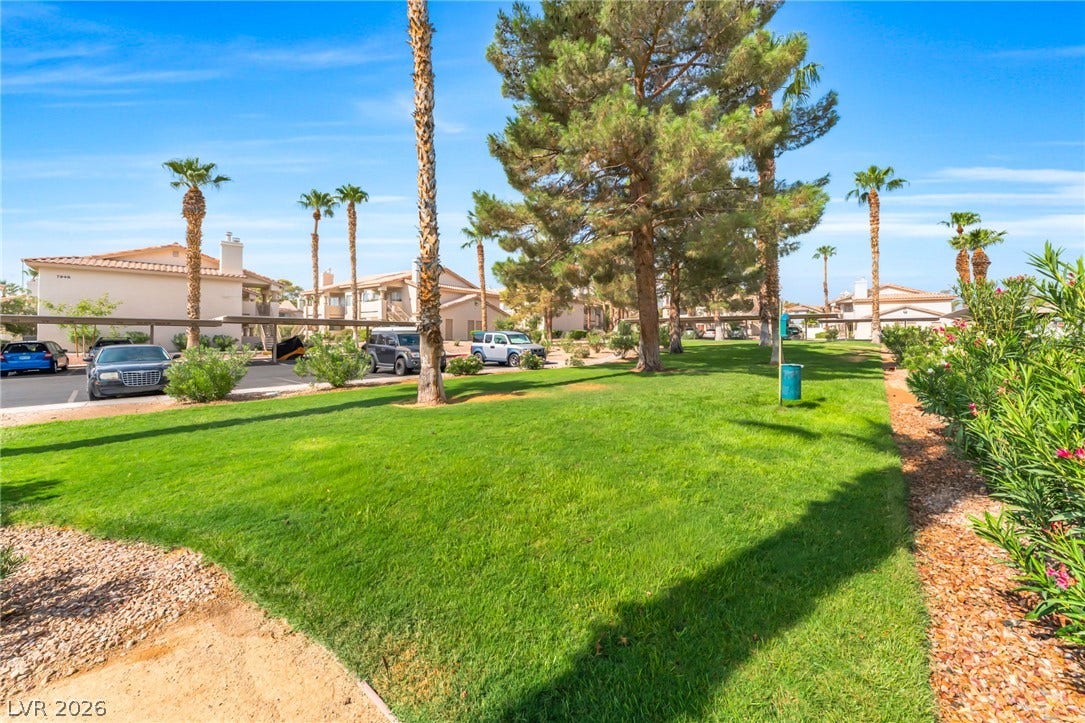 1017 Falconhead Lane, #102, Las Vegas, NV 89128 Mature trees and neat ground cover frame the shared green space of this community.