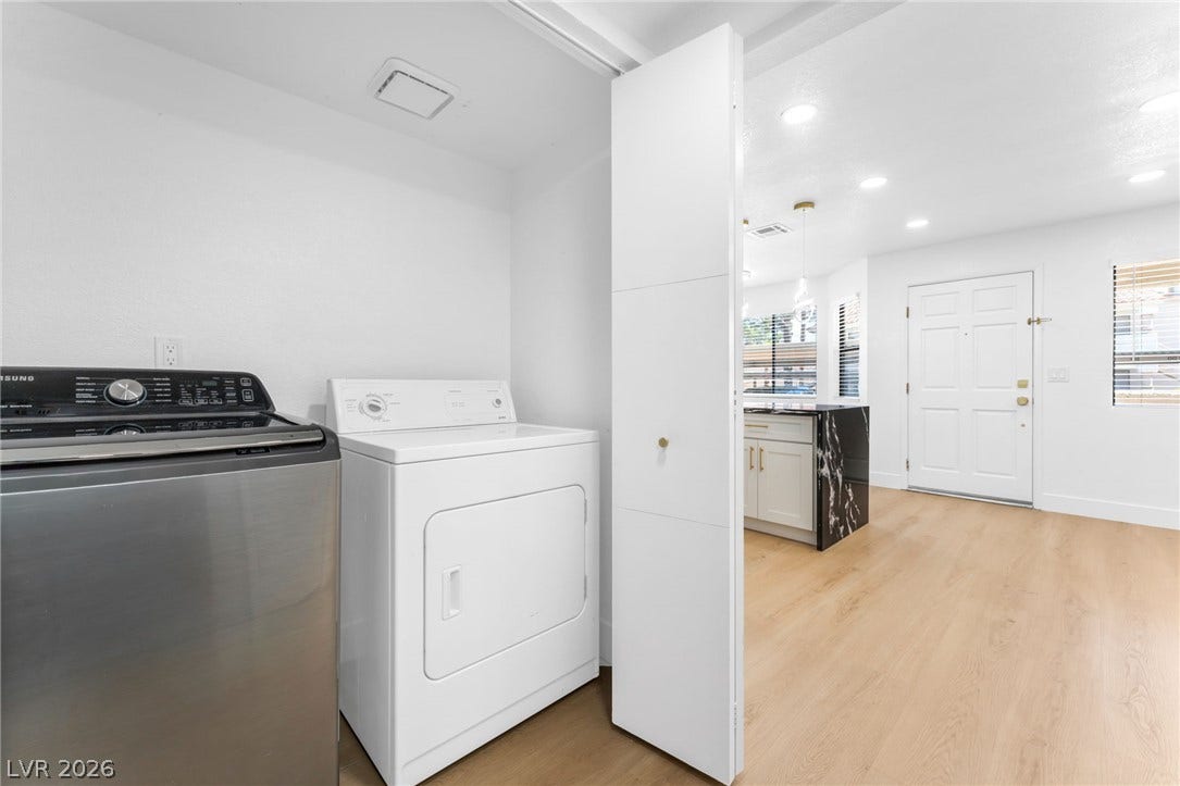1017 Falconhead Lane, #102, Las Vegas, NV 89128 Recessed lighting and light-toned wood flooring enhance this versatile indoor laundry area.