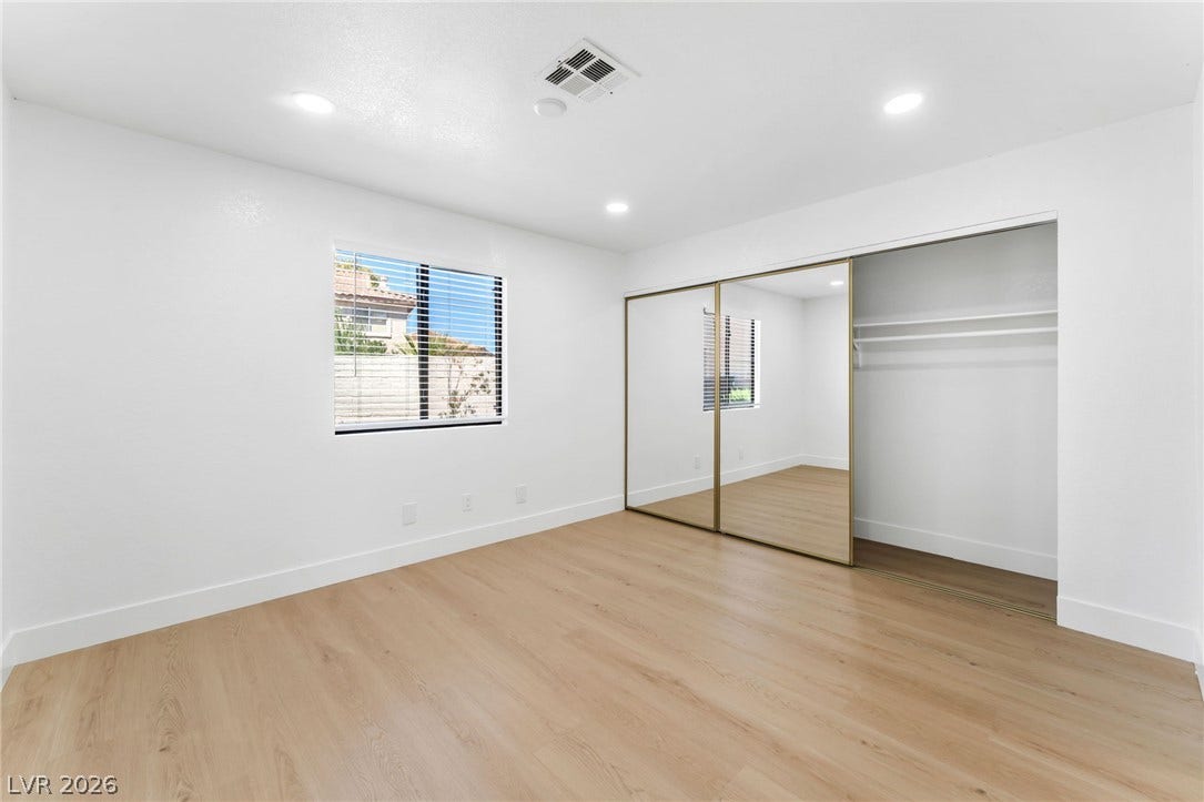 1017 Falconhead Lane, #102, Las Vegas, NV 89128 Gleaming wood floors and mirrored closet doors enhance this light-filled room.