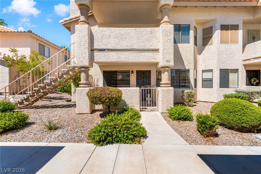 1017 Falconhead Lane, #102, Las Vegas, NV 89128 Classical columns and stucco finishes define this ground-level entry with a private gated courtyard.