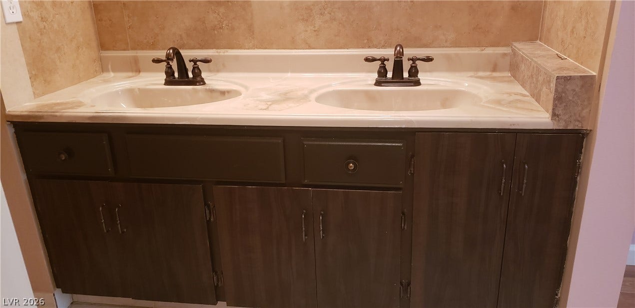 A spacious double vanity offers abundant storage and integrated sinks.