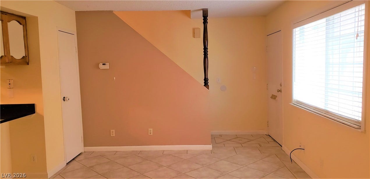 Tiled flooring and a large window define this functional living space.