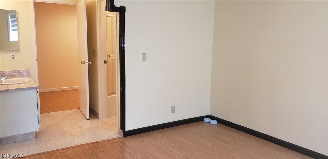 Smooth wood floors and crisp neutral walls define this versatile interior space.