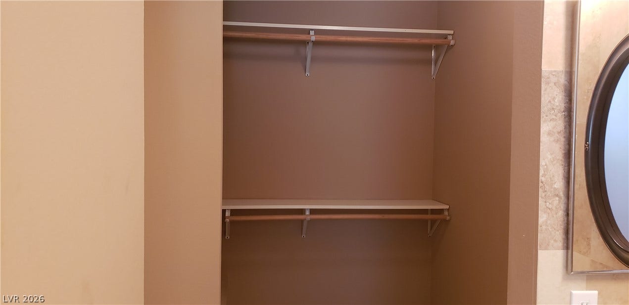 Double hanging rods and integrated shelving optimize storage capacity in this functional built-in closet.
