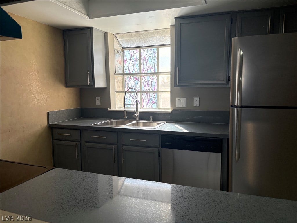 Ample cabinetry and stone countertops anchor this functional kitchen workspace.