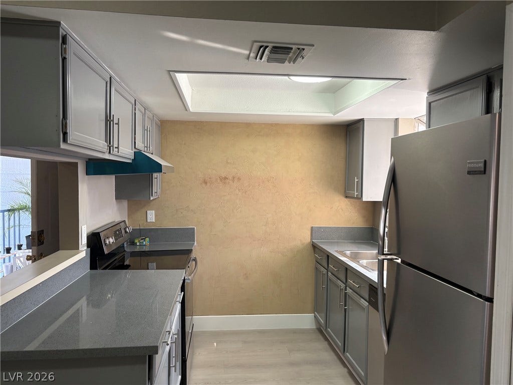 Streamlined cabinetry and sleek solid-surface countertops define this efficient galley workspace.