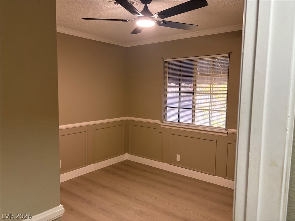 Classic wainscoting and smooth wood-look flooring define this versatile interior space.