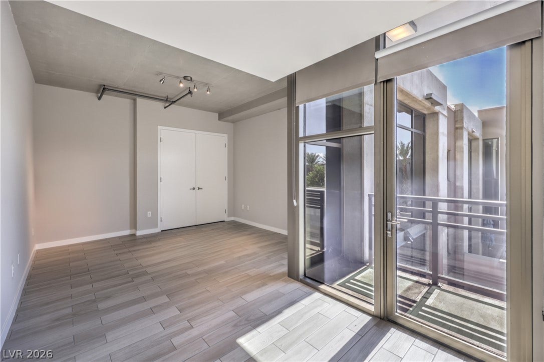 353 E Bonneville Avenue, #754, Las Vegas, NV 89101 Spacious Owners Suite with Balcony and Bathroom with Tile Flooring, Dual Sinks, and Tub/Shower Combination with Enclosure