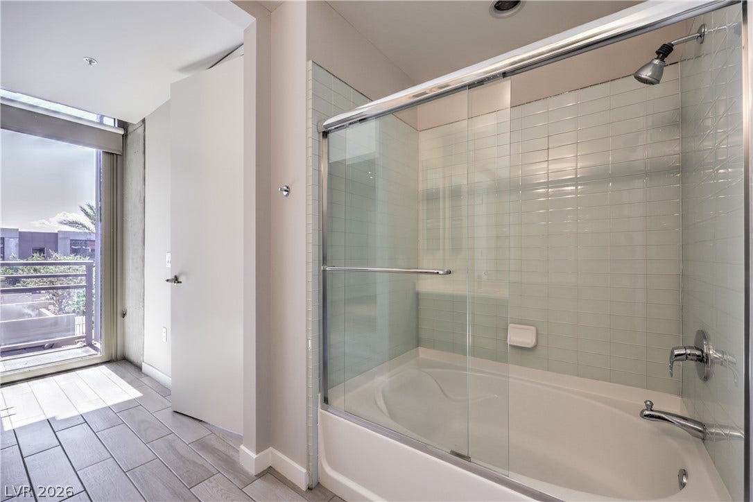 353 E Bonneville Avenue, #754, Las Vegas, NV 89101 Owners Bathroom with Tile Flooring, Dual Sinks, and Tub/Shower Combination with Enclosure
