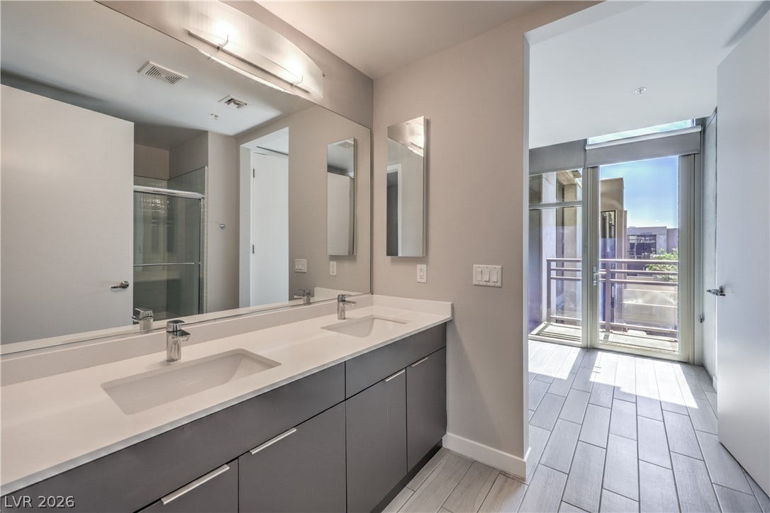 353 E Bonneville Avenue, #754, Las Vegas, NV 89101 Owner's Bathroom with Tile Flooring, Dual Sinks, and Tub/Shower Combination with Enclosure