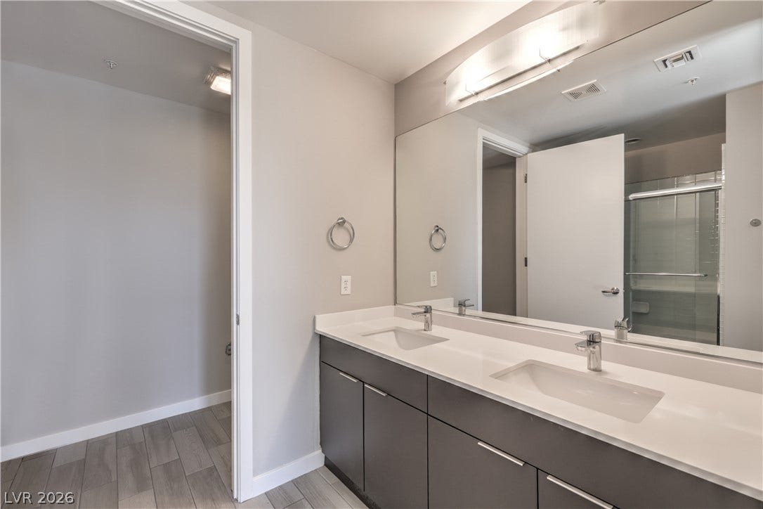 353 E Bonneville Avenue, #754, Las Vegas, NV 89101 Owner's Bathroom with Tile Flooring, Dual Sinks, and Tub/Shower Combination with Enclosure