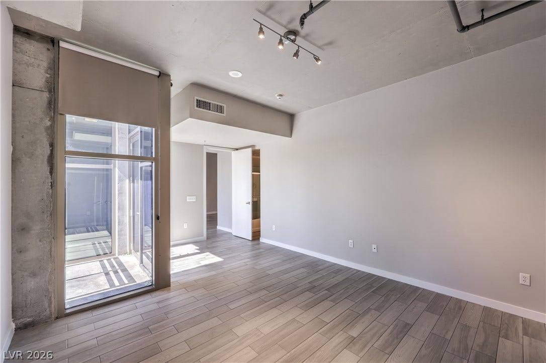 353 E Bonneville Avenue, #754, Las Vegas, NV 89101 Spacious Owners Suite with Balcony and Bathroom with Tile Flooring, Dual Sinks, and Tub/Shower Combination with Enclosure