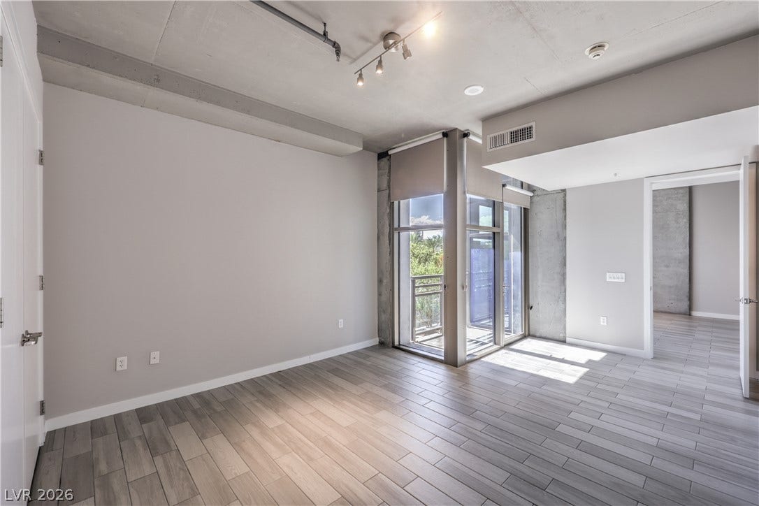 353 E Bonneville Avenue, #754, Las Vegas, NV 89101 Spacious Owners Suite with Balcony and Bathroom with Tile Flooring, Dual Sinks, and Tub/Shower Combination with Enclosure