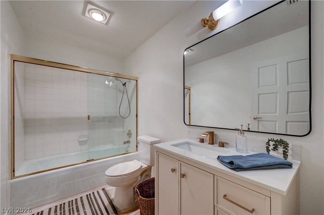3005 Plaza De Rosa, Las Vegas, NV 89102 Gold hardware and clean white tiling define this refreshed contemporary bathroom.