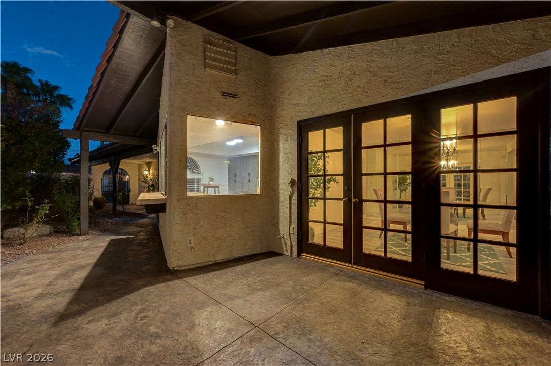 3005 Plaza De Rosa, Las Vegas, NV 89102 Multi-pane French doors open directly onto a covered concrete patio space.