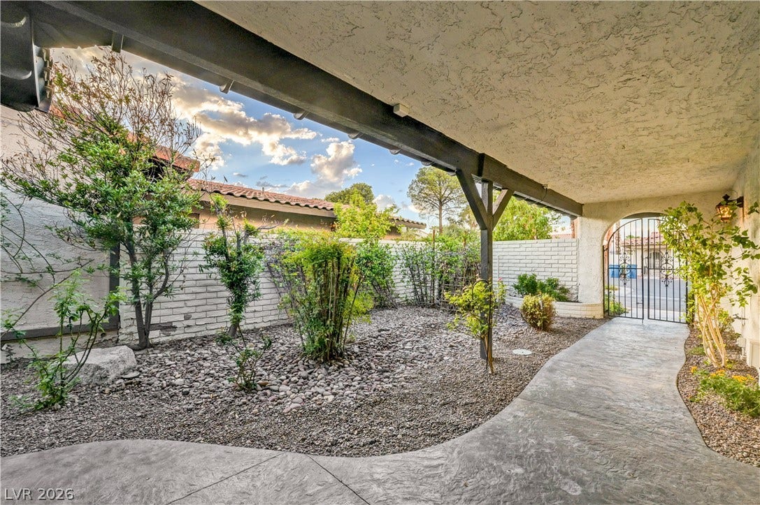 3005 Plaza De Rosa, Las Vegas, NV 89102 An inviting gated courtyard features a covered walkway, stamped concrete pathway, and low-maintenance landscaping.