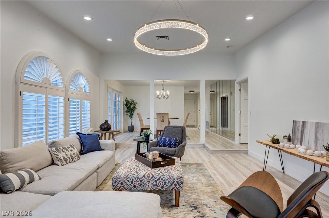 3005 Plaza De Rosa, Las Vegas, NV 89102 Sunlight streams through elegant arched windows onto a spacious, open living area with modern lighting.