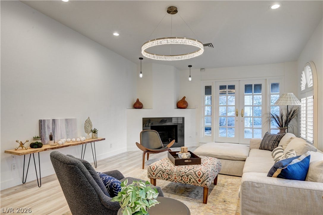 3005 Plaza De Rosa, Las Vegas, NV 89102 Gleaming hardwood floors and a modern fireplace elevate this inviting living space.