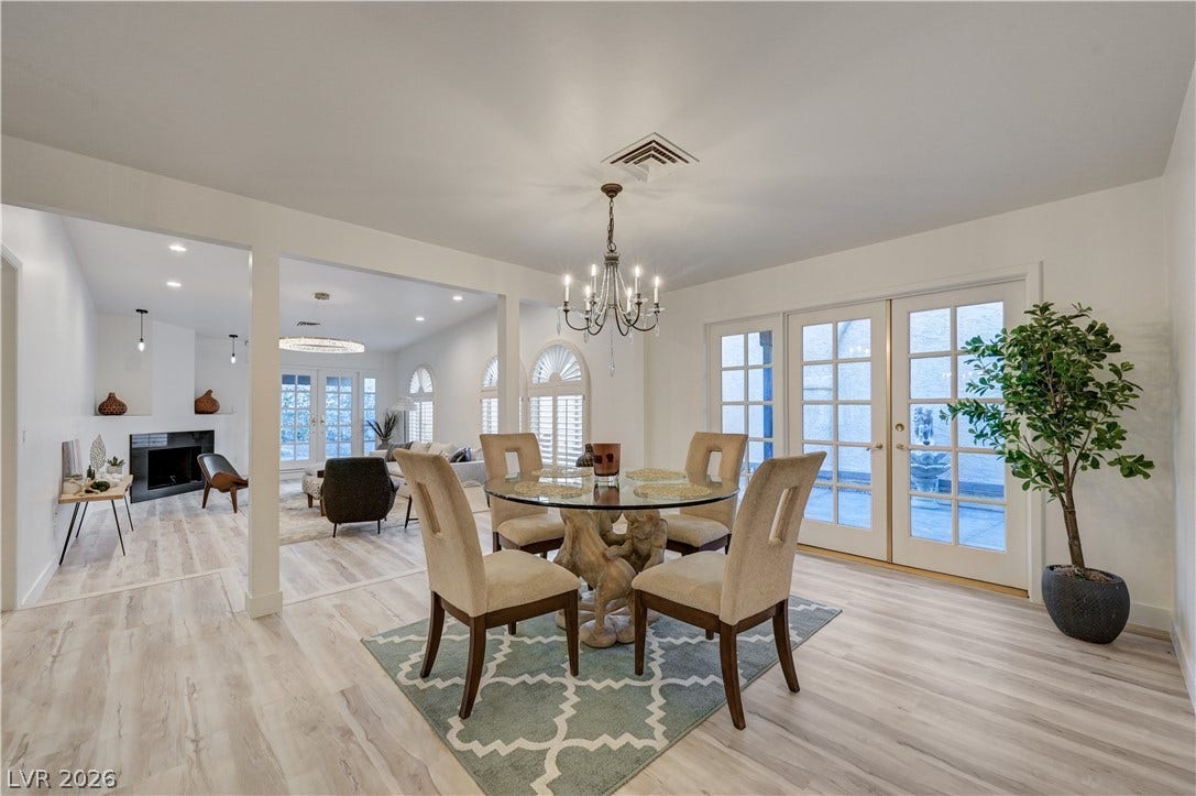 3005 Plaza De Rosa, Las Vegas, NV 89102 Glass doors and classic wood-look flooring establish a welcoming ambiance in this open dining space.