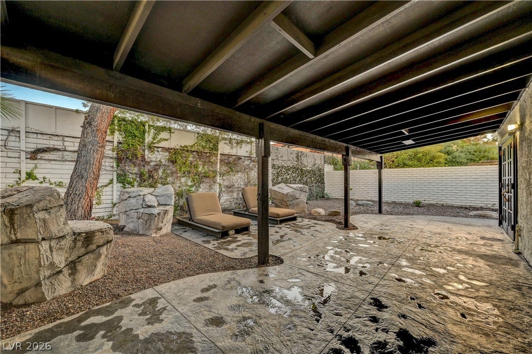 3005 Plaza De Rosa, Las Vegas, NV 89102 A covered concrete patio provides sheltered outdoor living space adjacent to the yard.