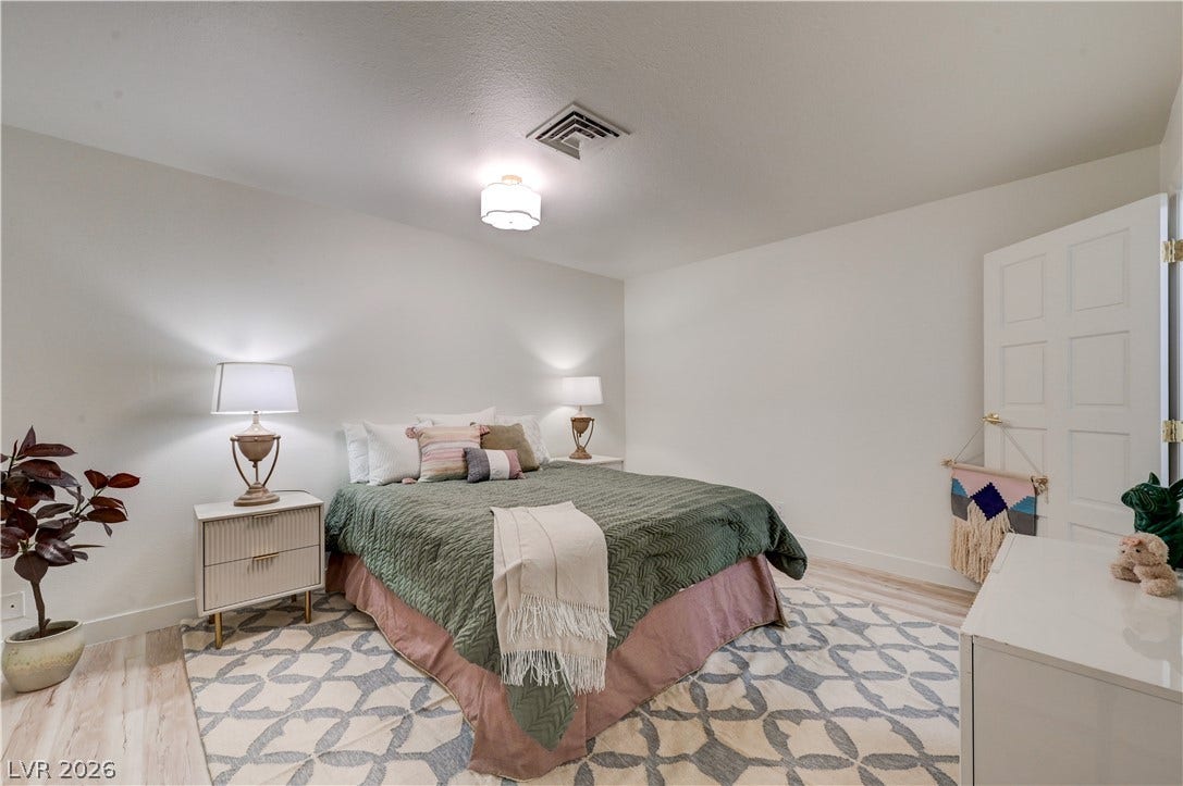 3005 Plaza De Rosa, Las Vegas, NV 89102 Smooth plaster walls and light wood-tone flooring anchor this inviting bedroom space.
