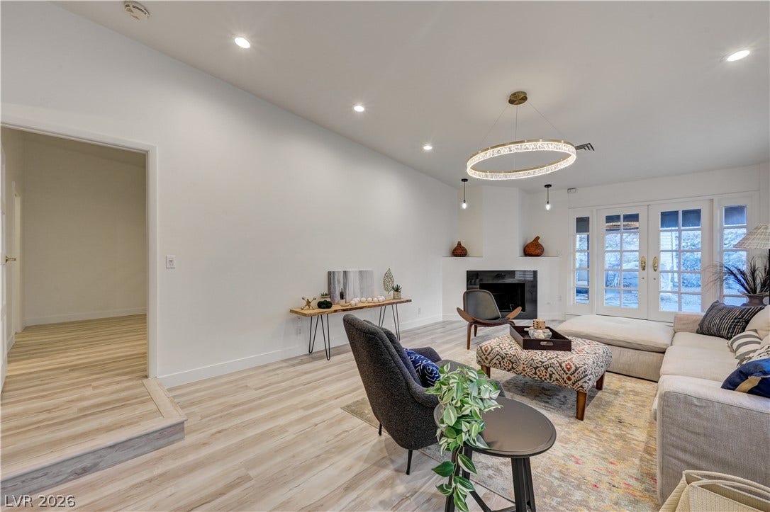 3005 Plaza De Rosa, Las Vegas, NV 89102 Gleaming wood floors and a sleek fireplace anchor this airy living space.