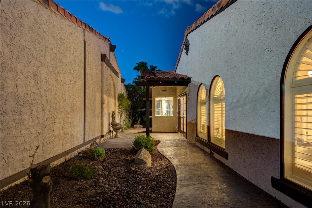 3005 Plaza De Rosa, Las Vegas, NV 89102 A curved concrete walkway guides guests toward the entrance of this Spanish-style stucco home.