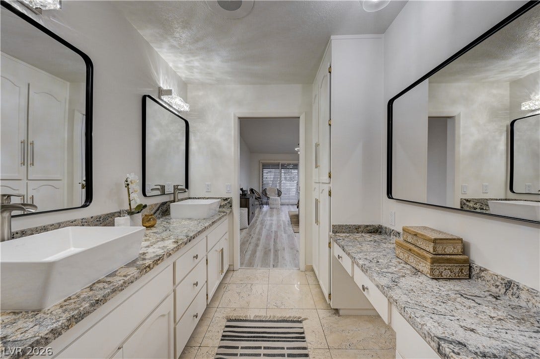 3005 Plaza De Rosa, Las Vegas, NV 89102 Polished stone countertops and dual vessel sinks define this spacious vanity area.