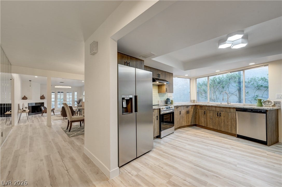 3005 Plaza De Rosa, Las Vegas, NV 89102 Warm wood cabinetry and modern stainless appliances define this spacious culinary space with durable wood-look flooring.