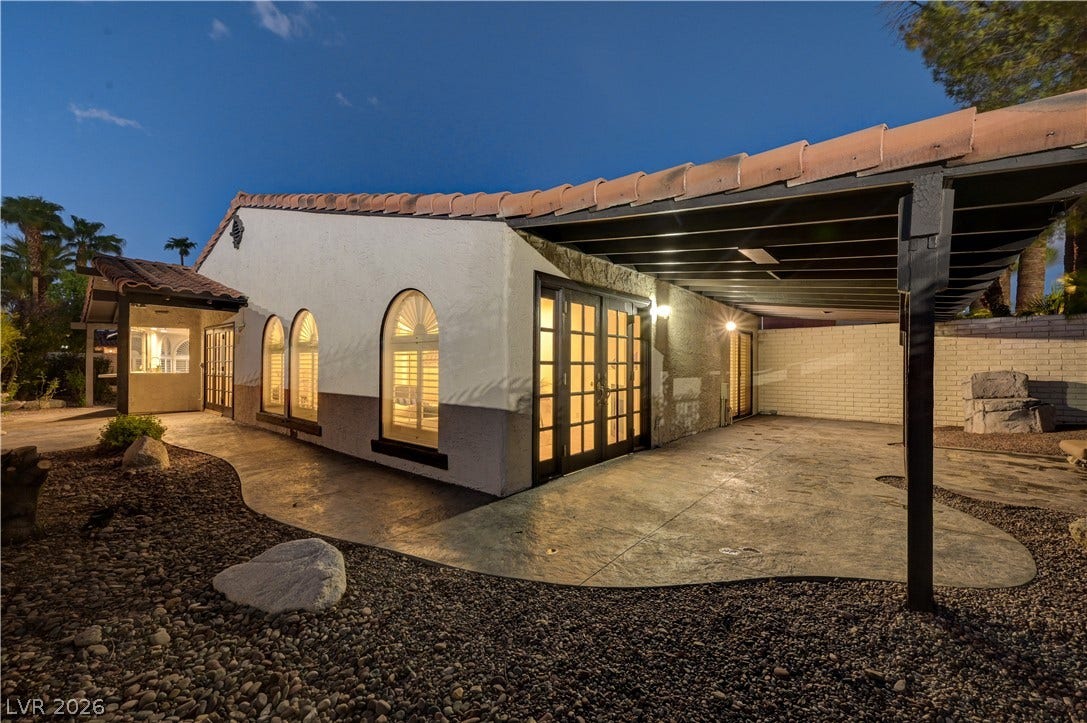 3005 Plaza De Rosa, Las Vegas, NV 89102 An inviting covered patio offers seamless indoor-outdoor transition alongside distinctive arched windows.