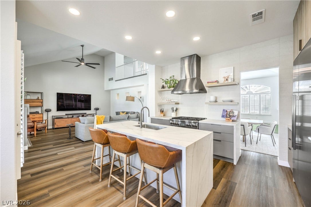 1863 Bogey Way, Henderson, NV 89074 Gleaming hardwood floors run through a modern, open kitchen featuring a marble waterfall island.