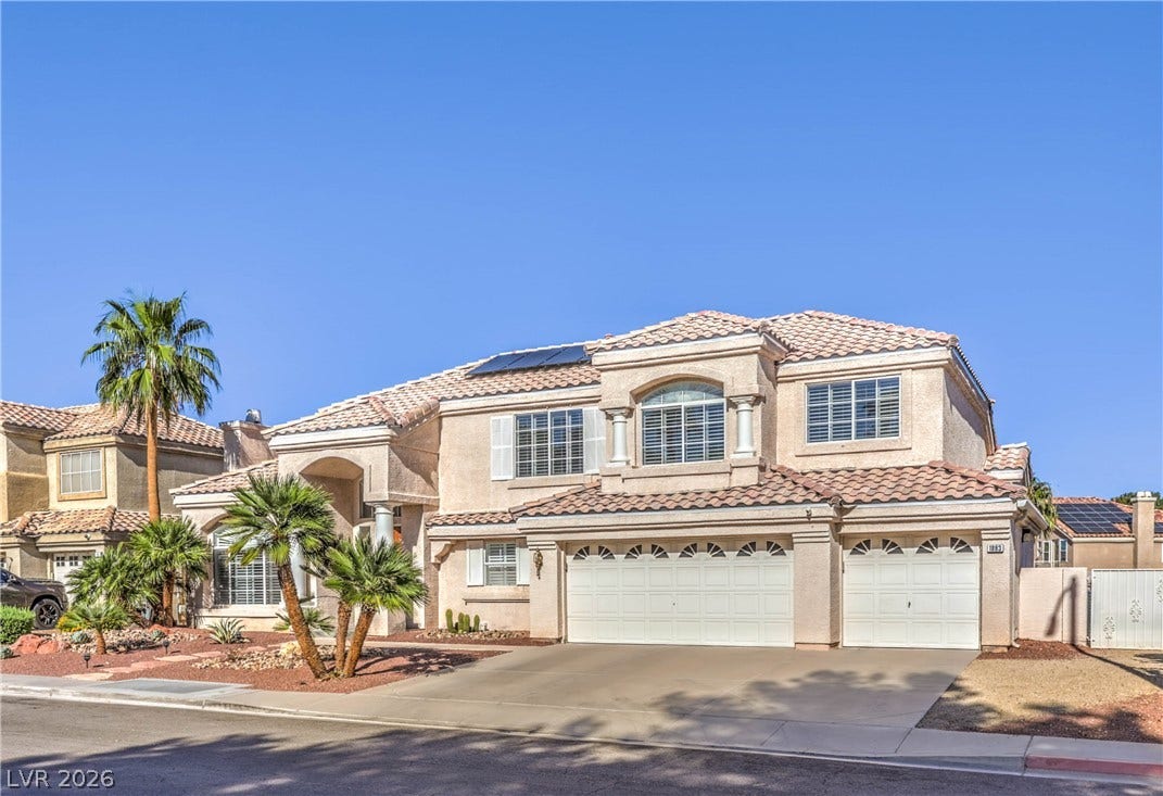 1863 Bogey Way, Henderson, NV 89074 Spanish tile roofing and pristine stucco siding define this multi-level suburban residence.
