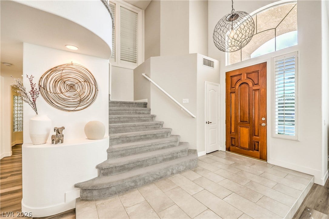 1863 Bogey Way, Henderson, NV 89074 A grand wood entry door and tiled foyer welcome guests into this airy home.