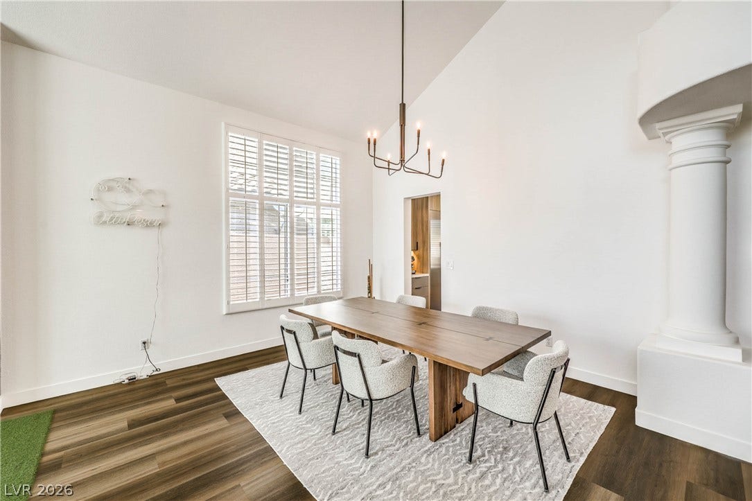 1863 Bogey Way, Henderson, NV 89074 High ceilings and plantation shutters elevate this elegant dining space with rich wood floors.