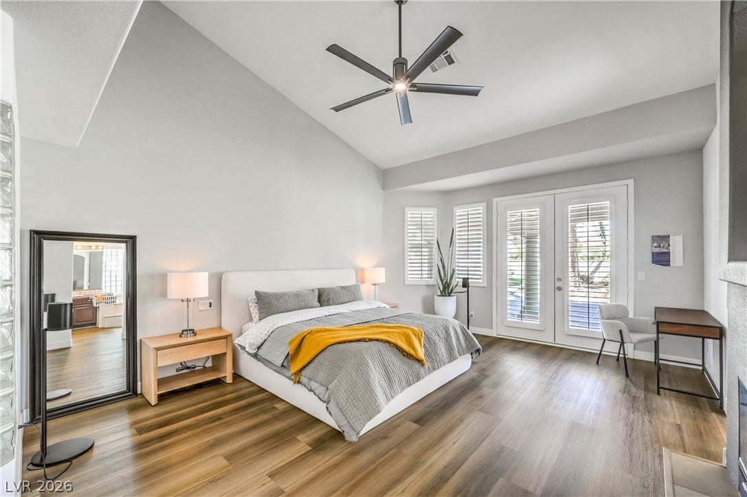 1863 Bogey Way, Henderson, NV 89074 High vaulted ceilings and glass doors with built-in shutters elevate this airy bedroom retreat.