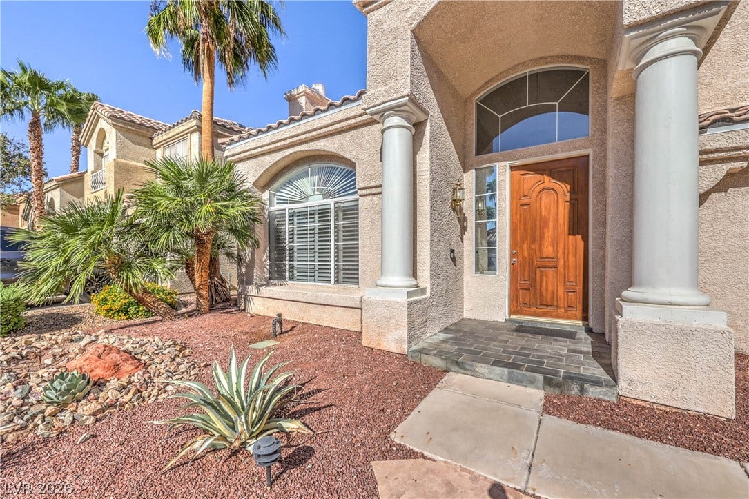 1863 Bogey Way, Henderson, NV 89074 An inviting entryway welcomes guests with towering columns and a classic wooden front door.