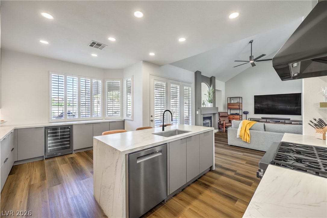 1863 Bogey Way, Henderson, NV 89074 Rich wood flooring runs through this airy open-concept kitchen and adjoining living area.