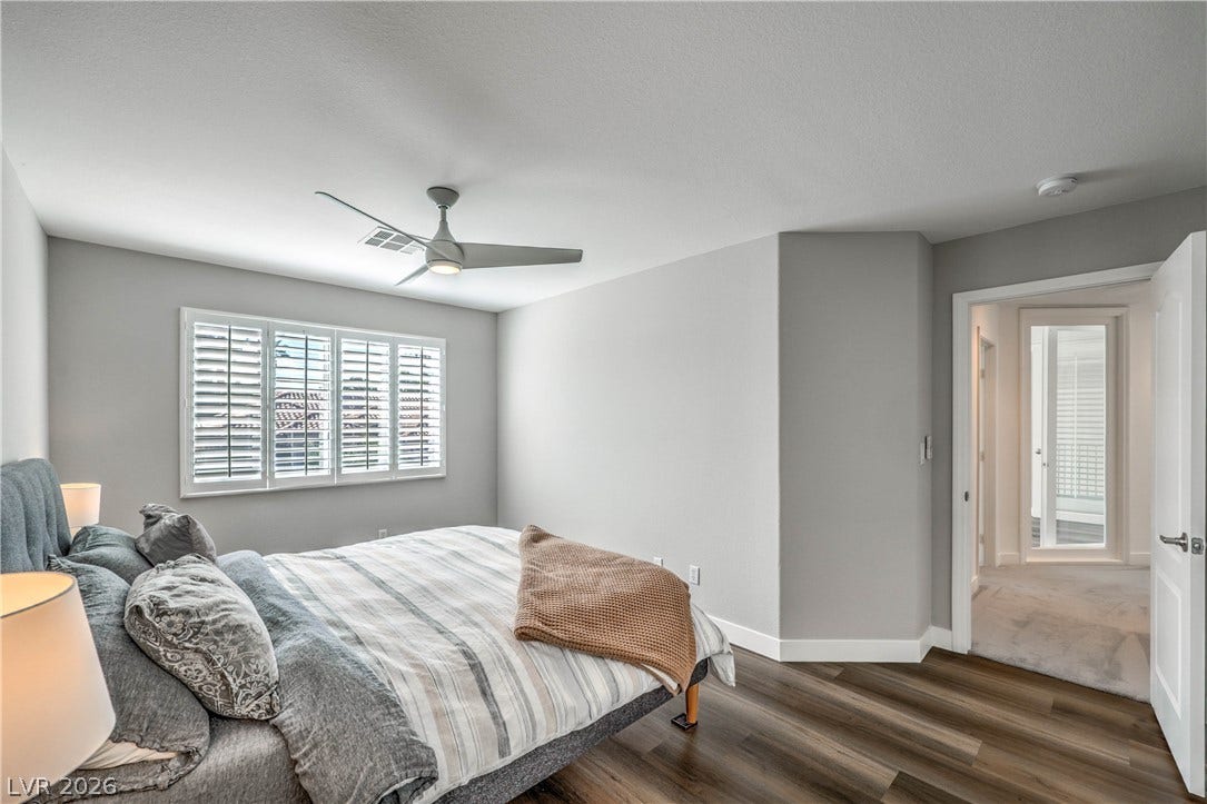 1863 Bogey Way, Henderson, NV 89074 Gleaming wood-look floors complement the clean lines of this modern bedroom retreat.