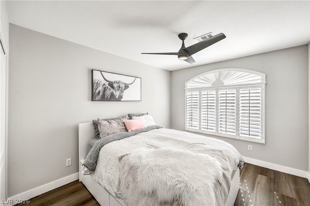1863 Bogey Way, Henderson, NV 89074 Rich wood-inspired flooring pairs with a classic arched window in this quiet space.
