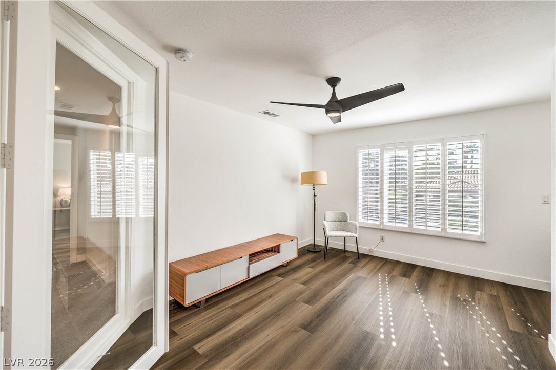1863 Bogey Way, Henderson, NV 89074 Gleaming hardwood floors and classic plantation shutters elevate this versatile main-level living space.