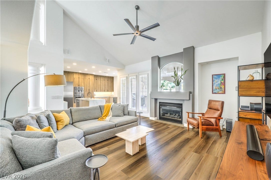 1863 Bogey Way, Henderson, NV 89074 Vaulted ceilings soar over a modern living room anchored by a contemporary fireplace.