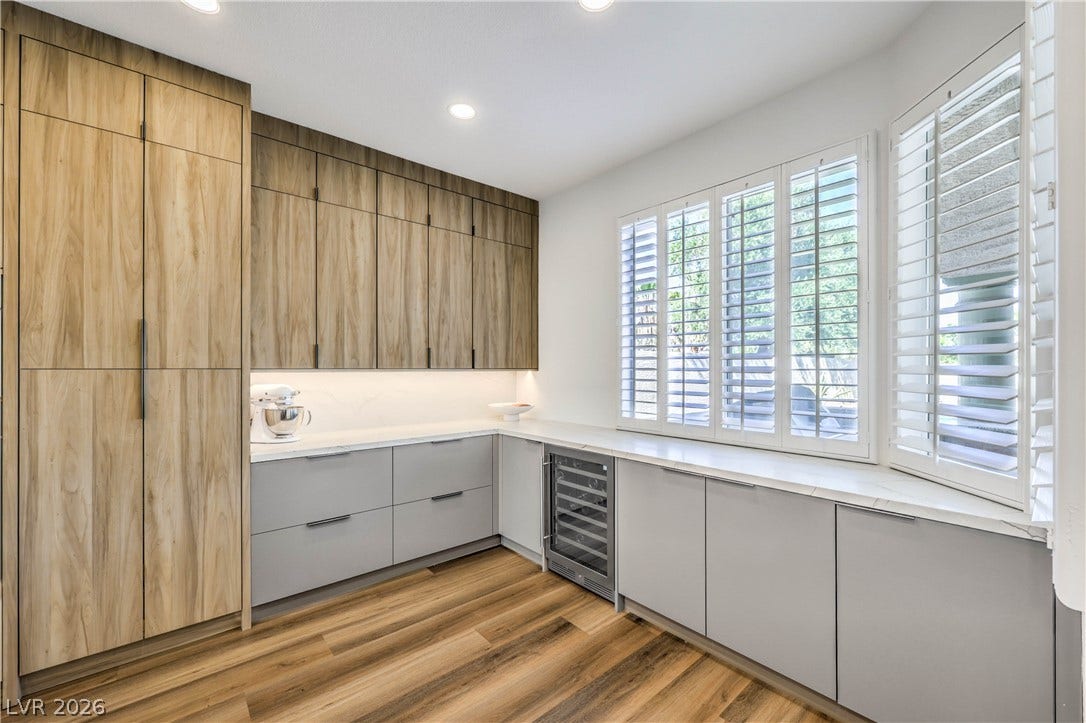 1863 Bogey Way, Henderson, NV 89074 Rich wood grain cabinetry and smooth hard flooring frame this modern workspace area.