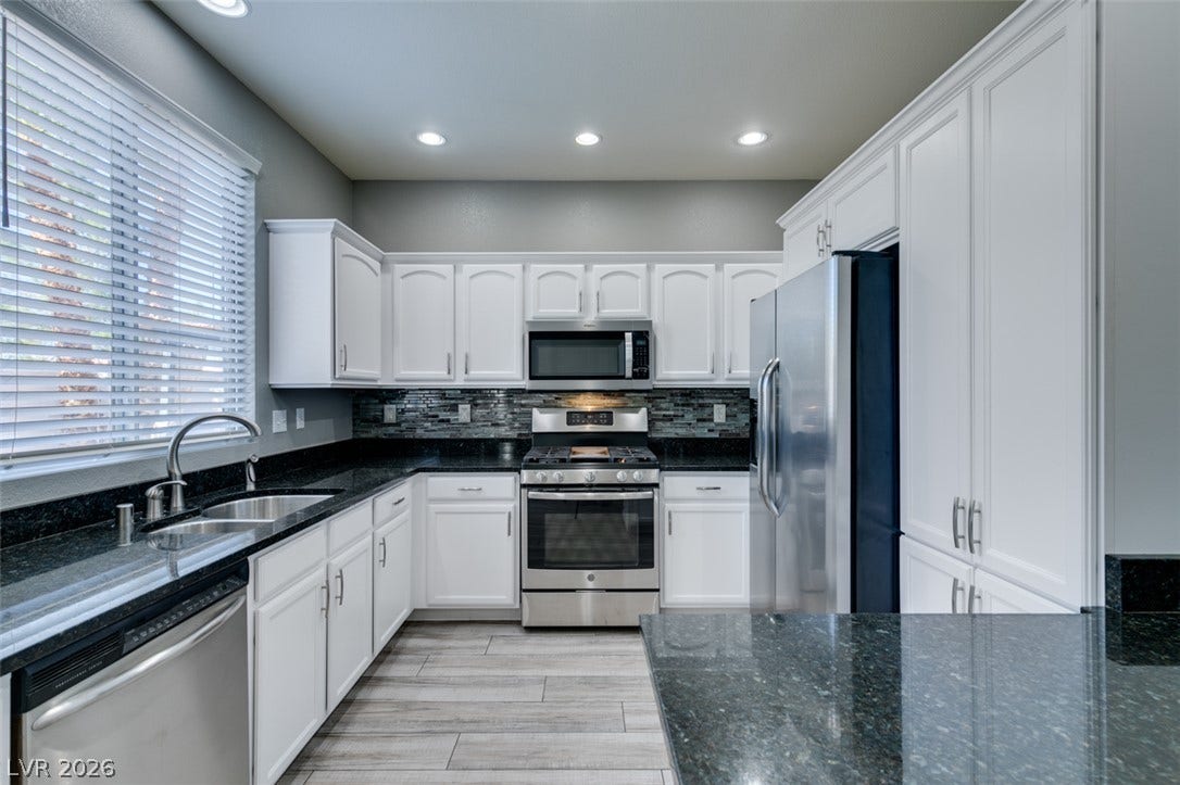 Gleaming stone countertops and modern cabinetry define this carefully updated workspace.