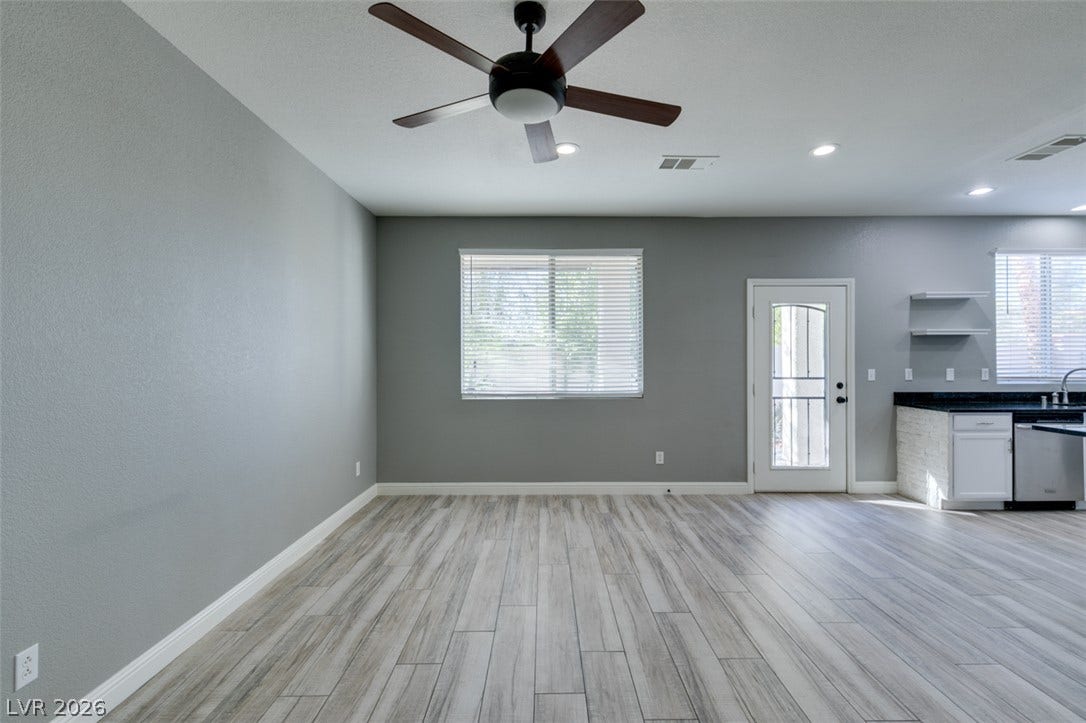 Clean lines and smooth flooring define this versatile, open living and dining area.