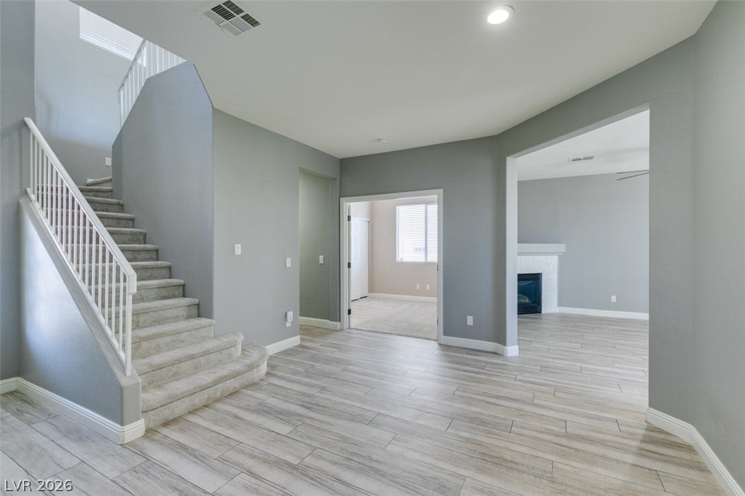 Gleaming wood-look floors and an open floorplan connect the airy living spaces.