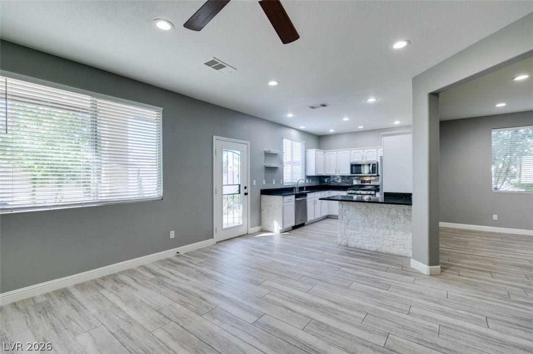 An open floorplan seamlessly connects the airy living area with the updated kitchen space.