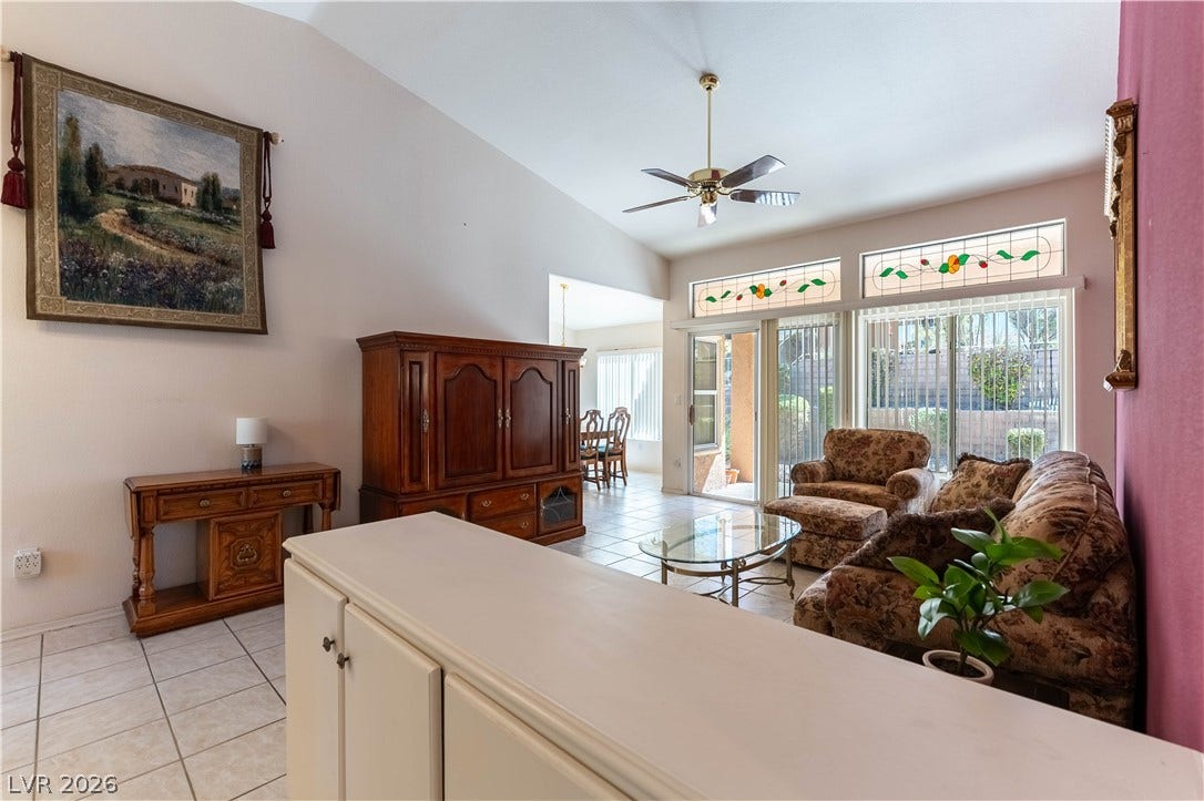 10005 Arbuckle Drive, Las Vegas, NV 89134 High ceilings and arched glass transoms elevate this airy living space with tile flooring.
