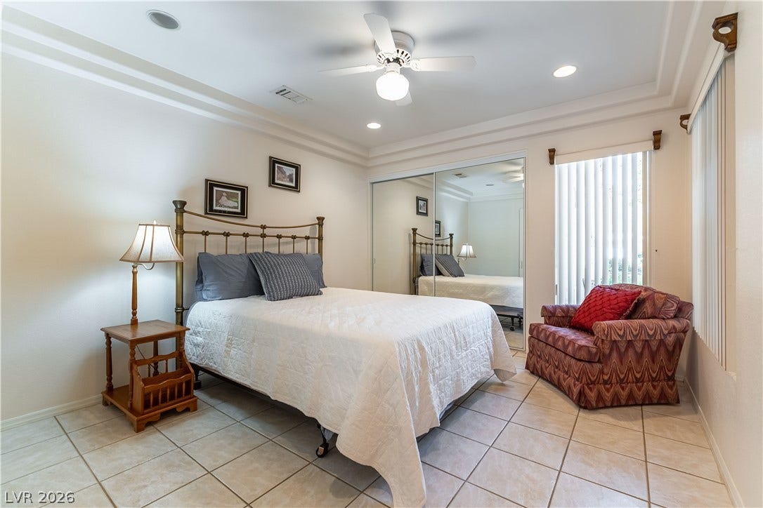 10005 Arbuckle Drive, Las Vegas, NV 89134 Tiled flooring and elegant crown molding define this comfortable sleeping space.