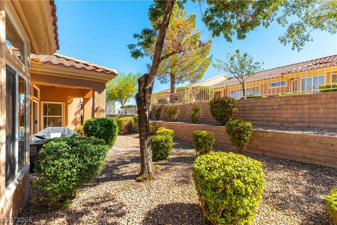 10005 Arbuckle Drive, Las Vegas, NV 89134 Multi-level stone retaining walls frame the low-maintenance desert landscaping of this private side yard.